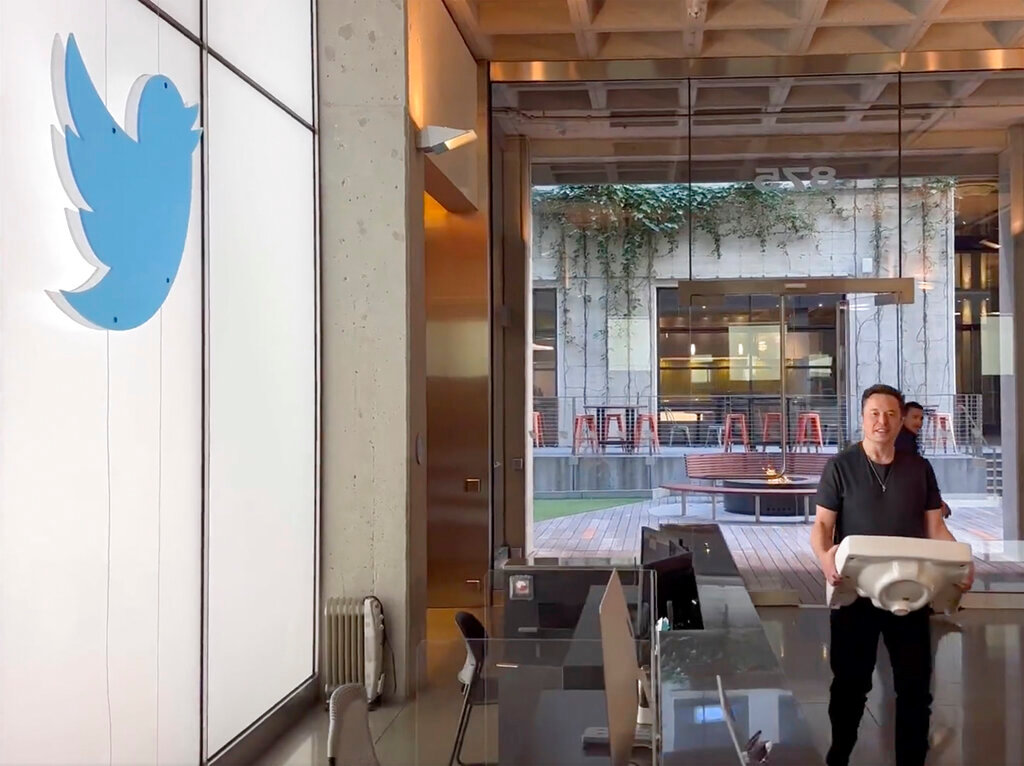 This image from the Twitter page of Elon Musk shows Musk entering Twitter headquarters carrying a sink through the lobby area on Wednesday, Oct. 26, 2022, in San Francisco. (Twitter page of Elon Musk via AP)