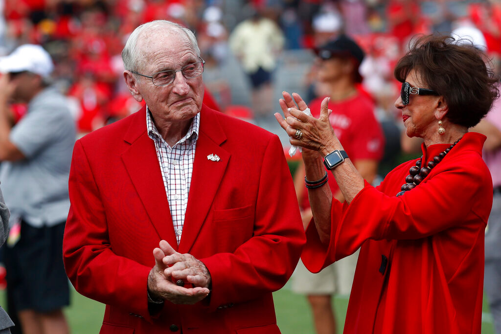 Former head Georgia football coach and athletic director Vince Dooley and his wife Barbara react during a ceremony to name the field at Sanford Stadium in his honor before an NCAA college football game Saturday, Sept. 7, 2019, in Athens, Ga. (AP Photo/John Bazemore, File)