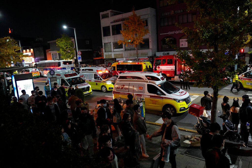 Ambulances carrying victims head to the hospital near the scene of a deadly accident in Seoul, South Korea, Sunday, Oct. 30, 2022. (AP Photo/Lee Jin-man)