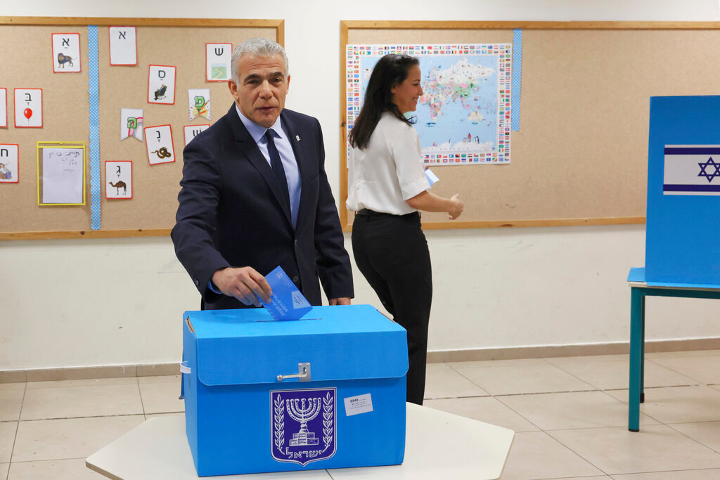 Israeli Prime Minister Yair Lapid casts his vote at a polling station in Israel's coastal city of Tel Aviv in the country's fifth election in four years in Tel Aviv Tuesday, Nov. 1, 2022. (Jack Guez/Pool Photo via AP)
