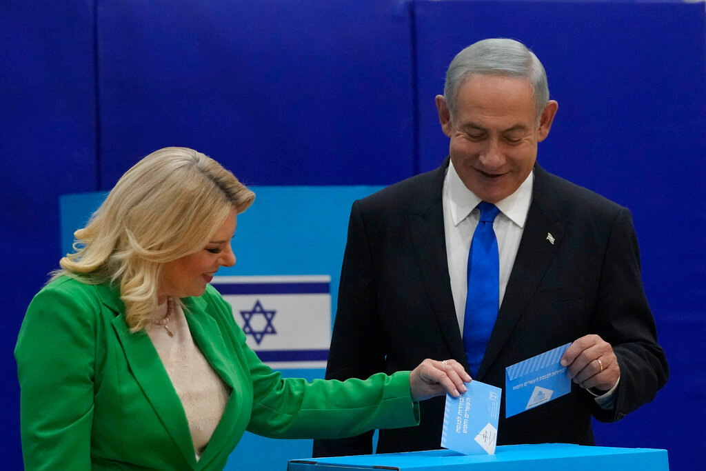 Likud party chairman Benjamin Netanyahu and his wife Sara cast their ballots during Israeli elections in Jerusalem, Tuesday, Nov. 1, 2022. (AP Photo/Maya Alleruzzo)