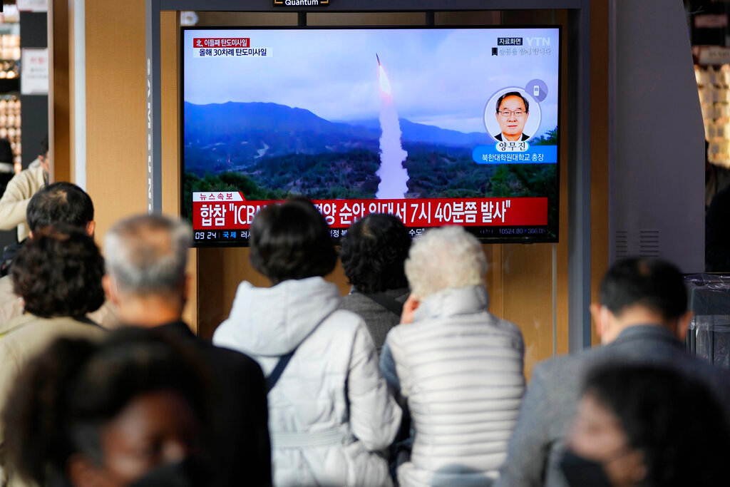 A TV screen showing a news program reporting about North Korea's missile launch with file footage is seen at the Seoul Railway Station in Seoul, South Korea, Thursday, Nov. 3, 2022. (AP Photo/Lee Jin-man)