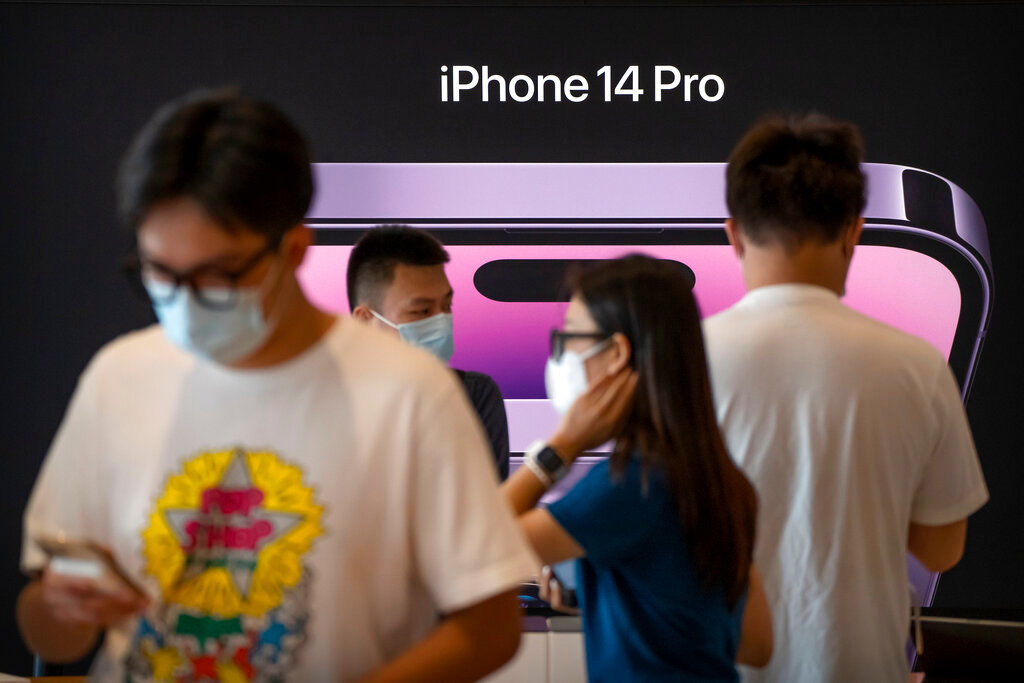 Customers shop at an Apple Store on the first day of sale for the Apple iPhone 14 in Beijing, China on Sept. 16, 2022. (AP Photo/Mark Schiefelbein, File)