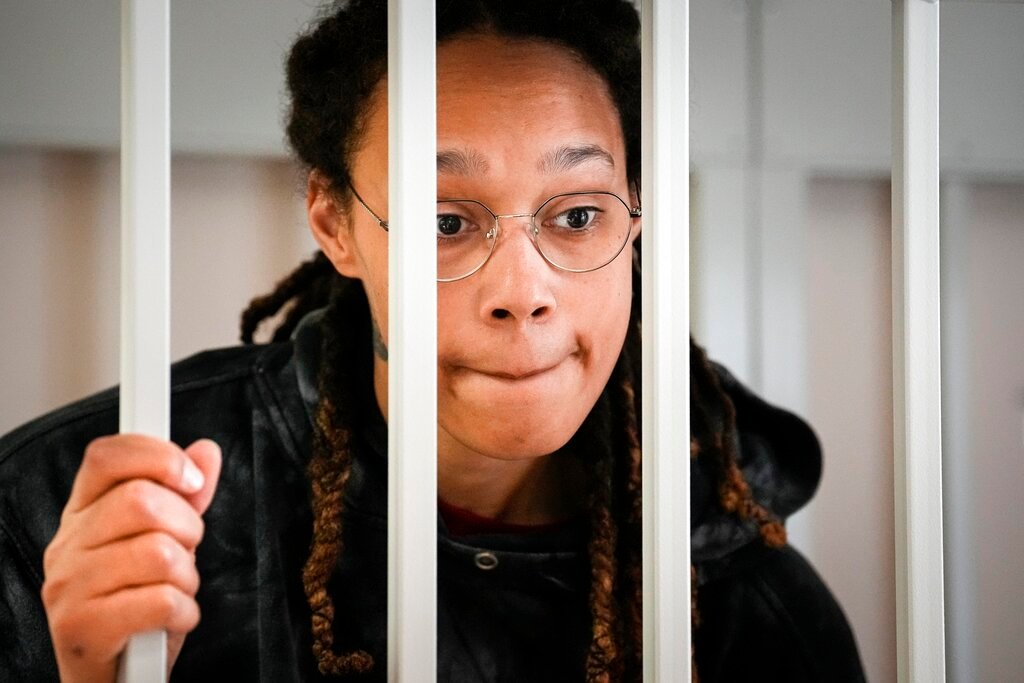 WNBA star and two-time Olympic gold medalist Brittney Griner speaks to her lawyers standing in a cage at a courtroom prior to a hearing in Khimki just outside Moscow, Russia, July 26, 2022. (AP Photo/Alexander Zemlianichenko, Pool, File)