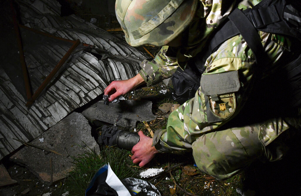 A Ukrainian police investigator works at the site of recent Russian shelling in Kramatorsk, Ukraine, Tuesday, Nov. 8, 2022. (AP Photo/Andriy Andriyenko)