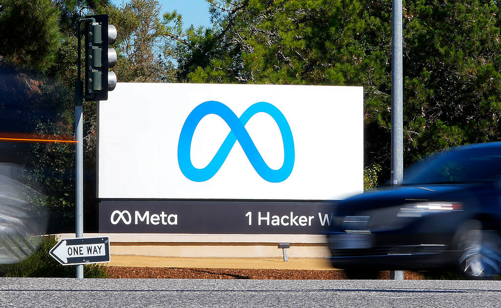 A car passes Facebook's new Meta logo on a sign at the company headquarters on Oct. 28, 2021, in Menlo Park, Calif. (AP Photo/Tony Avelar, File)
