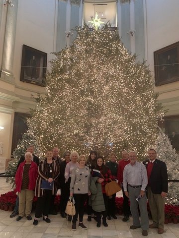 Visitors pose beside a Christmas tree during a 2021 Prayer Tour of the Georgia state Capitol on Dec. 8, 2021.