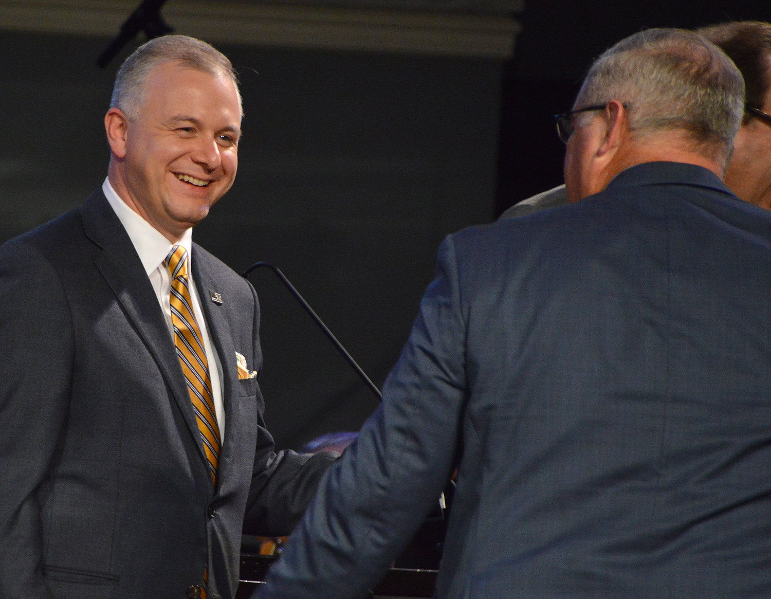 Newly elected president Josh Saefkow walks off the stage after his election as president was announced by outgoing president Kevin Williams, right, at the 200th annual meeting of the Georgia Baptist Convention in Augusta, Ga, Tuesday, Nov. 15, 2022. (Index/Henry Durand)