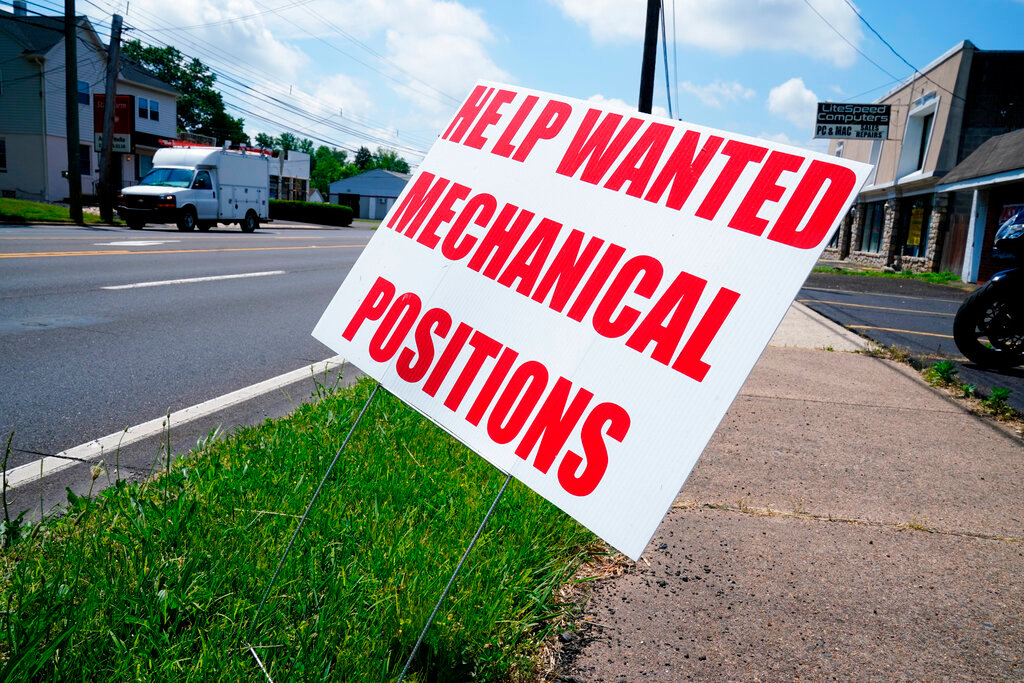 A help wanted sign is posted on the side of a road Thursday, June 2, 2022 in this file photo. (AP Photo/Matt Rourke)