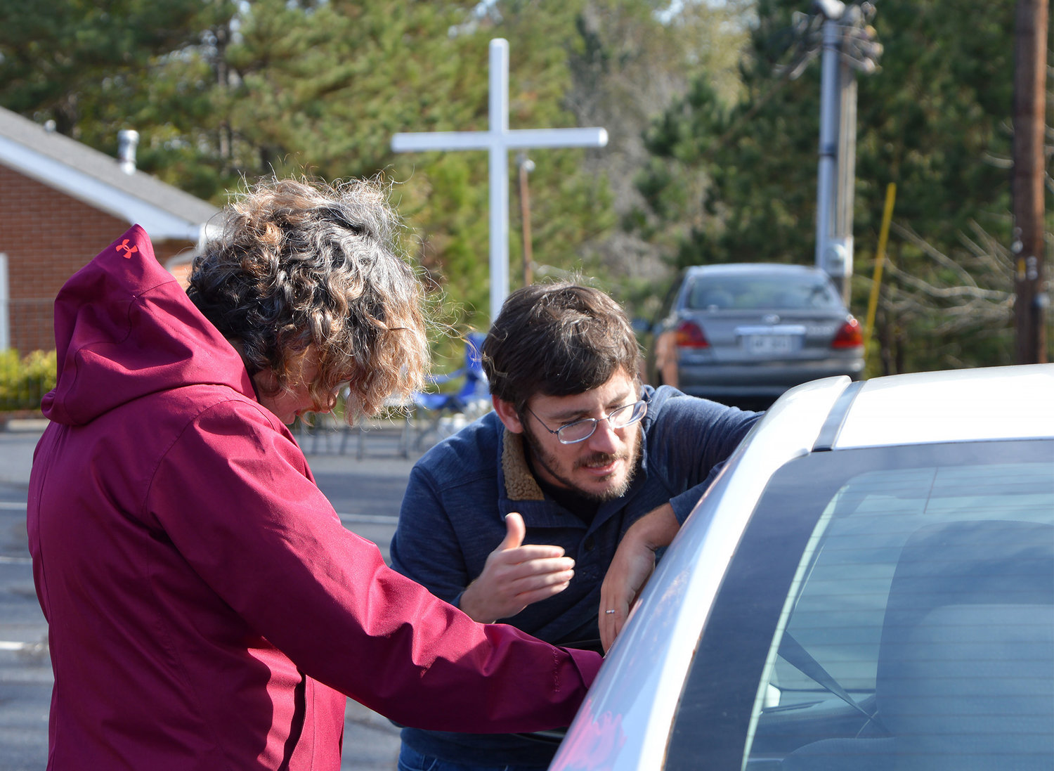 Pastor Jamie Hobbs and Debbie Lloyd, left, pray for a driver who pulled into New Hope First Baptist Church on Saturday, Nov. 19, 2022, in Dallas, Ga. (Index/Henry Durand)