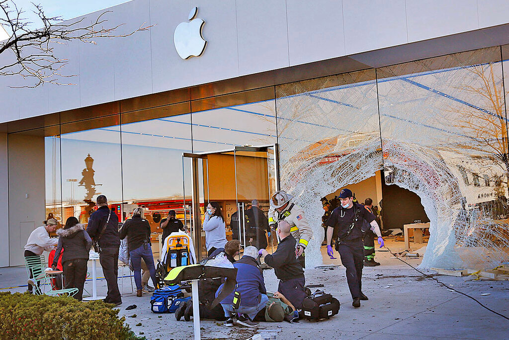 Emergency workers aid injured shoppers after an SUV drove into an Apple store, Monday, Nov. 21, 2022, in Hingham, Mass. Several people were injured in the incident, according to authorities. (Greg Derr/The Patriot Ledger via AP) BOSTON OUT