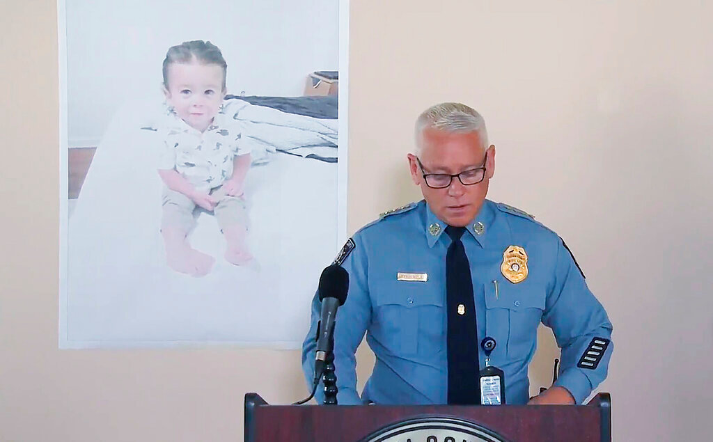 FLE - Chatham County Police Chief Jeff Hadley speaks to reporters as he stands in front of a large photo of missing toddler Quinton Simon at a police operations center being used in the search for the boy's remains just outside Savannah, Ga., on Oct. 18, 2022. Quinton's mother has been arrested in connection with the child's disappearance and presumed death, authorities said Monday, Nov. 21. (WSAV-TV via AP, File)
