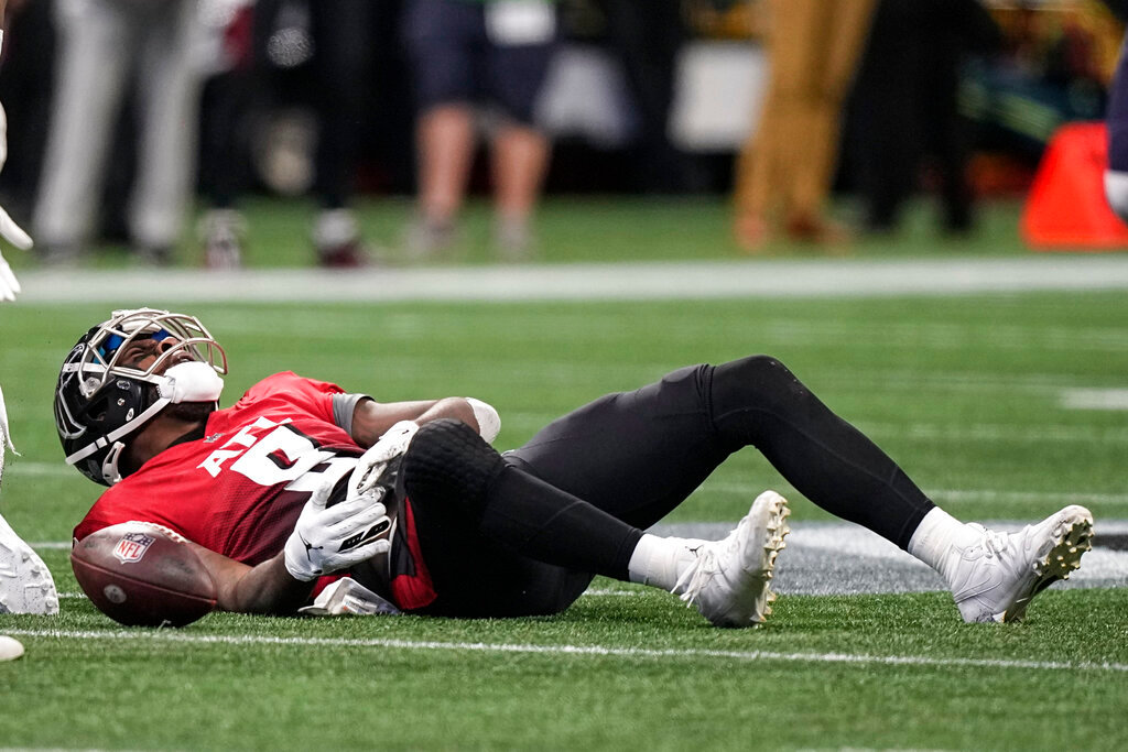 Atlanta Falcons tight end Kyle Pitts (8) lies on the turf after a hit against the Chicago Bears during the second half of an NFL football game, Sunday, Nov. 20, 2022, in Atlanta. (AP Photo/Brynn Anderson)