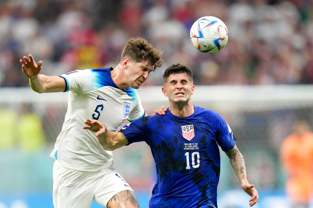 England's John Stones vies for the ball with Christian Pulisic of the United States, right, during the World Cup group B soccer match between England and The United States, at the Al Bayt Stadium in Al Khor , Qatar, Friday, Nov. 25, 2022. (AP Photo/Luca Bruno)