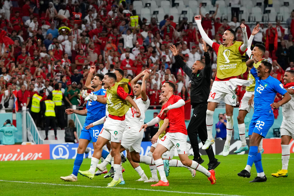 Morocco players celebrate after winning their World Cup group F soccer match against Belgium at the Al Thumama Stadium in Doha, Qatar, Sunday, Nov. 27, 2022. (AP Photo/Frank Augstein)
