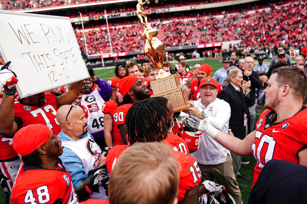 Georgia head coach Kirby Smart and his players hoist the Governor's Cup after defeating Georgia Tech, Saturday, Nov. 26, 2022, in Athens, Ga. (AP Photo/John Bazemore)