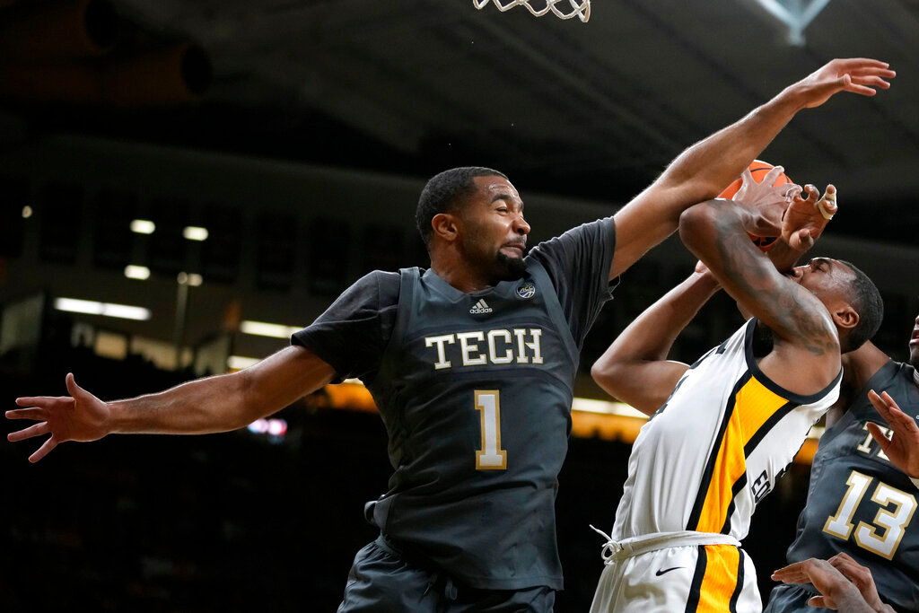 Iowa guard Tony Perkins is fouled by Georgia Tech guard Kyle Sturdivant (1) while driving to the basket during the second half Tuesday, Nov. 29, 2022, in Iowa City, Iowa. (AP Photo/Charlie Neibergall)
