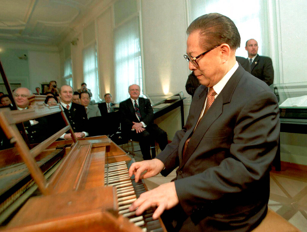 Chinese President Jiang Zemin plays Mozart's original piano during his visit to the birthplace of famed Austrian composer Wolfgang Amadeus Mozart in Salzburg, Austria, March 30, 1999. (AP Photo, File)