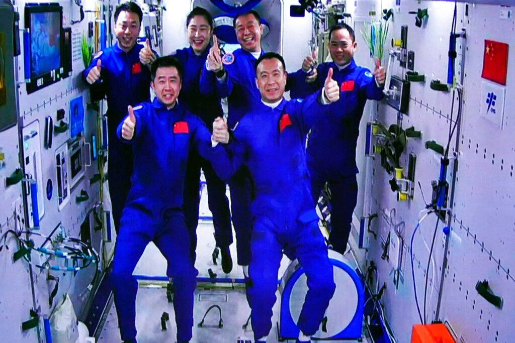 The Shenzhou-15 and Shenzhou-14 crew take a group picture Wednesday, Nov. 30, 2022, after three Chinese astronauts docked with their country's space station, where they will overlap for several days with the three-member crew already onboard and expand the facility to its maximum size. (Guo Zhongzheng/Xinhua via AP)