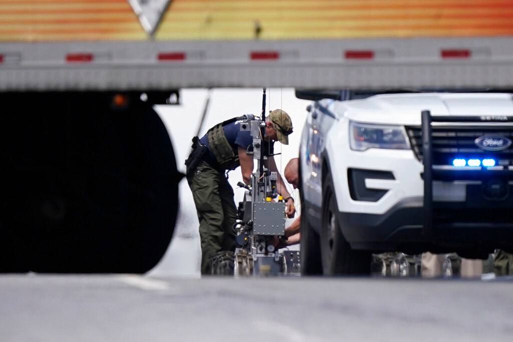 Authorities bring out a robot during a standoff with an armed suspect aboard a Greyhound bus on March 22, 2022, in Norcross, Ga. The suspect was taken into custody without injury.  (AP Photo/Brynn Anderson, File)