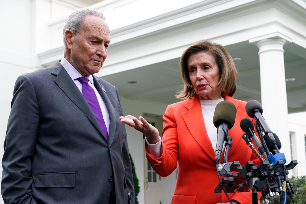 Senate Majority Leader Chuck Schumer of N.Y., right, listens as House Speaker Nancy Pelosi of Calif., left, speaks to reporters at the White House in Washington, Nov. 29, 2022, about their meeting with President Joe Biden. (AP Photo/Susan Walsh, File)