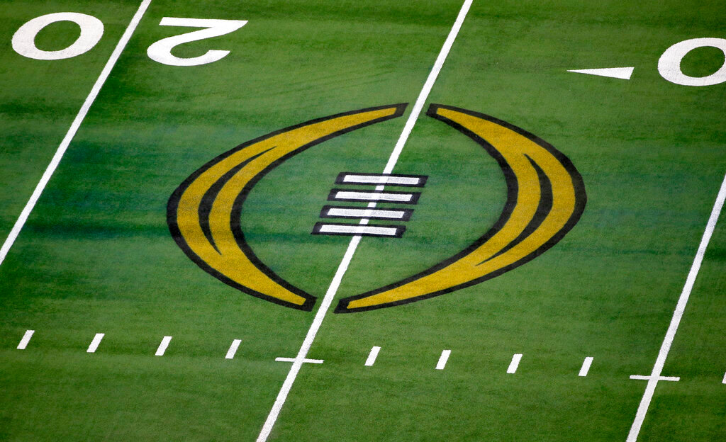 The College Football Playoff logo is shown on the field at AT&T Stadium before the Rose Bowl NCAA college football game between Notre Dame and Alabama in Arlington, Texas, Jan. 1, 2021. (AP Photo/Roger Steinman, File)