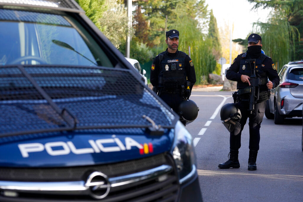 Police officers cordon off the area next to the Ukrainian embassy in Madrid, Spain, Wednesday, Nov. 30, 2022. (AP Photo/Paul White)