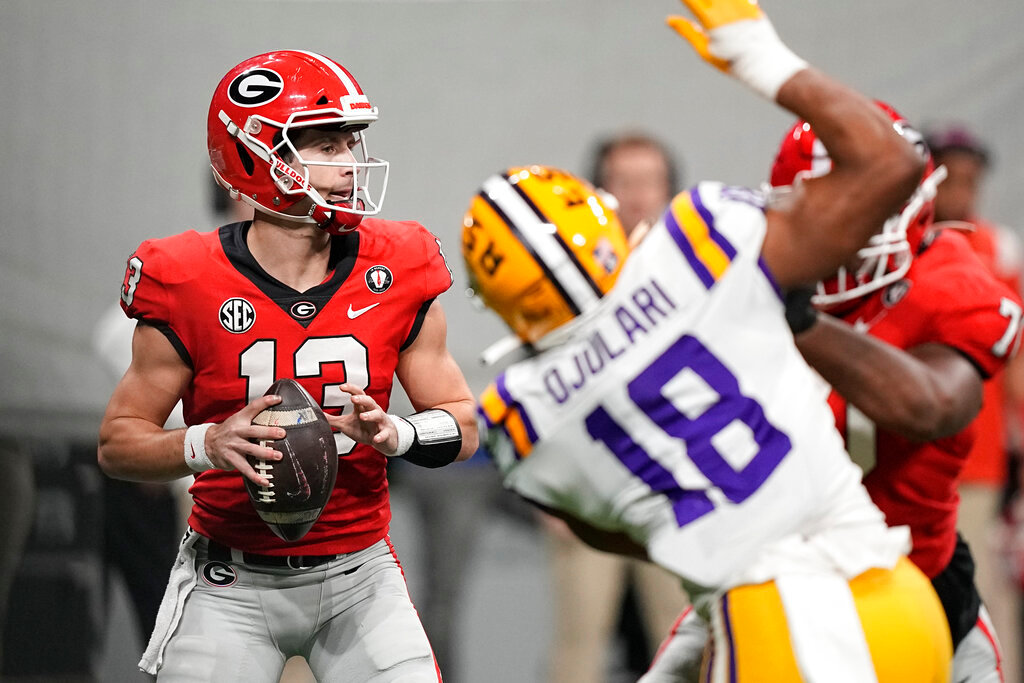 Georgia quarterback Stetson Bennett (13) sets back to pass in the first half of the Southeastern Conference championship NCAA college football game against LSU, Saturday, Dec. 3, 2022, in Atlanta. (AP Photo/Brynn Anderson)