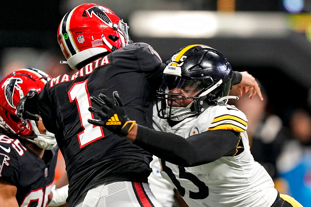 Atlanta Falcons quarterback Marcus Mariota (1) passes the ball as Pittsburgh Steelers linebacker Devin Bush (55) makes a hit during the second half of an NFL football game, Sunday, Dec. 4, 2022, in Atlanta. (AP Photo/Brynn Anderson)