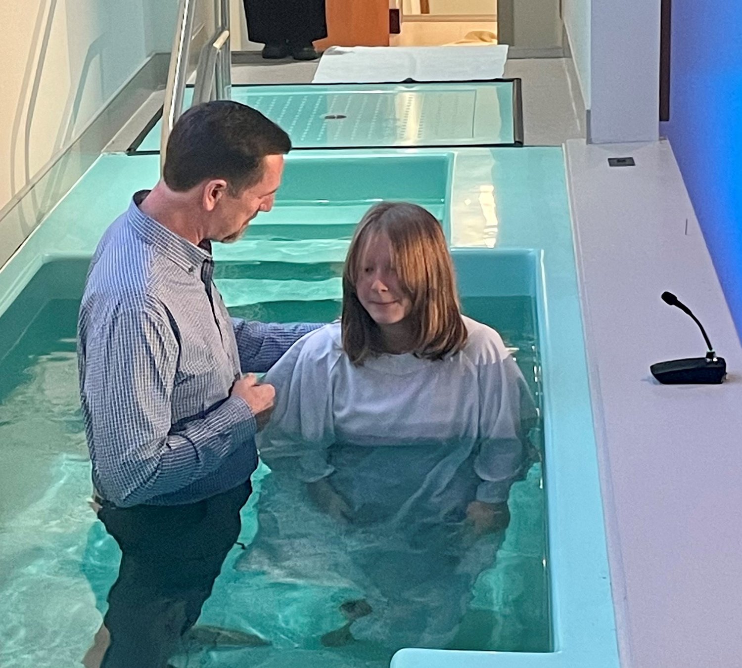 International Mission Board President Paul Chitwood baptizes his youngest daughter, Lilly, at their church in Glen Allen, Va.