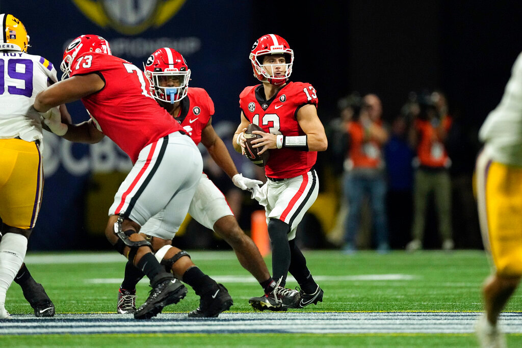 Georgia quarterback Stetson Bennett (13) looks for an open receiver in the first half of the Southeastern Conference Championship football game against the LSU Saturday, Dec. 3, 2022 in Atlanta. (AP Photo/John Bazemore)