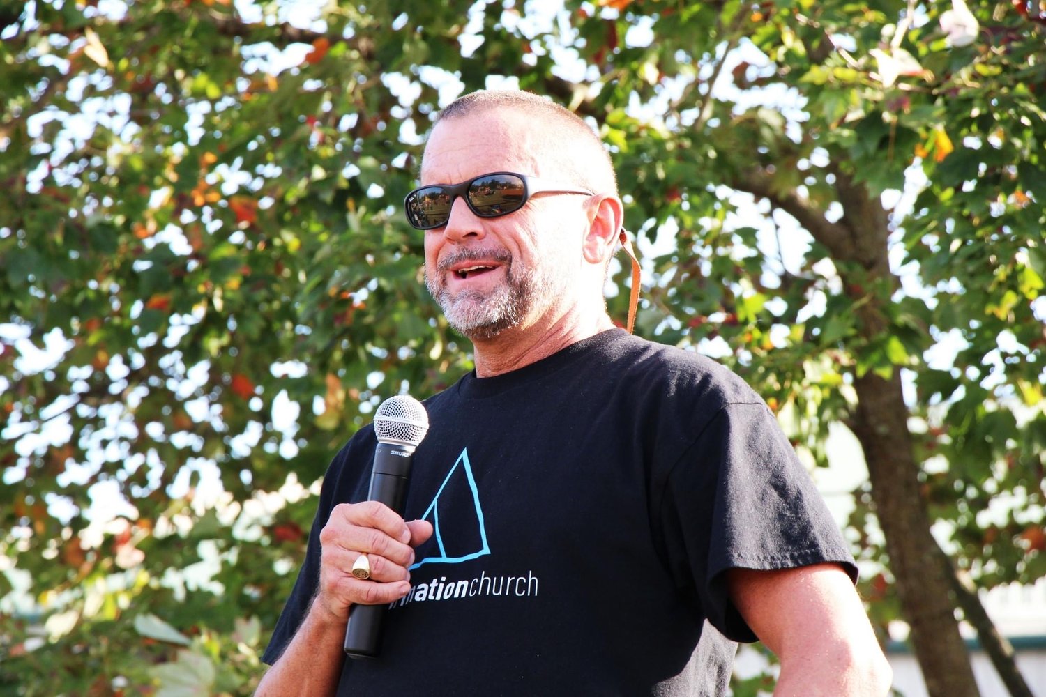 Pastor Mike Dorough addresses the large crowd that came for a block party in October.