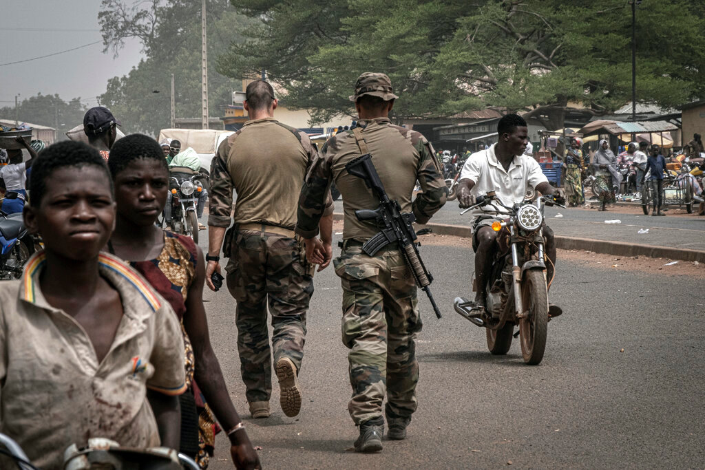 French army military instructors walk on one of the main roads in Tanguietan, northern Benin, March 28, 2022. (AP Photo/Marco Simoncelli, File)