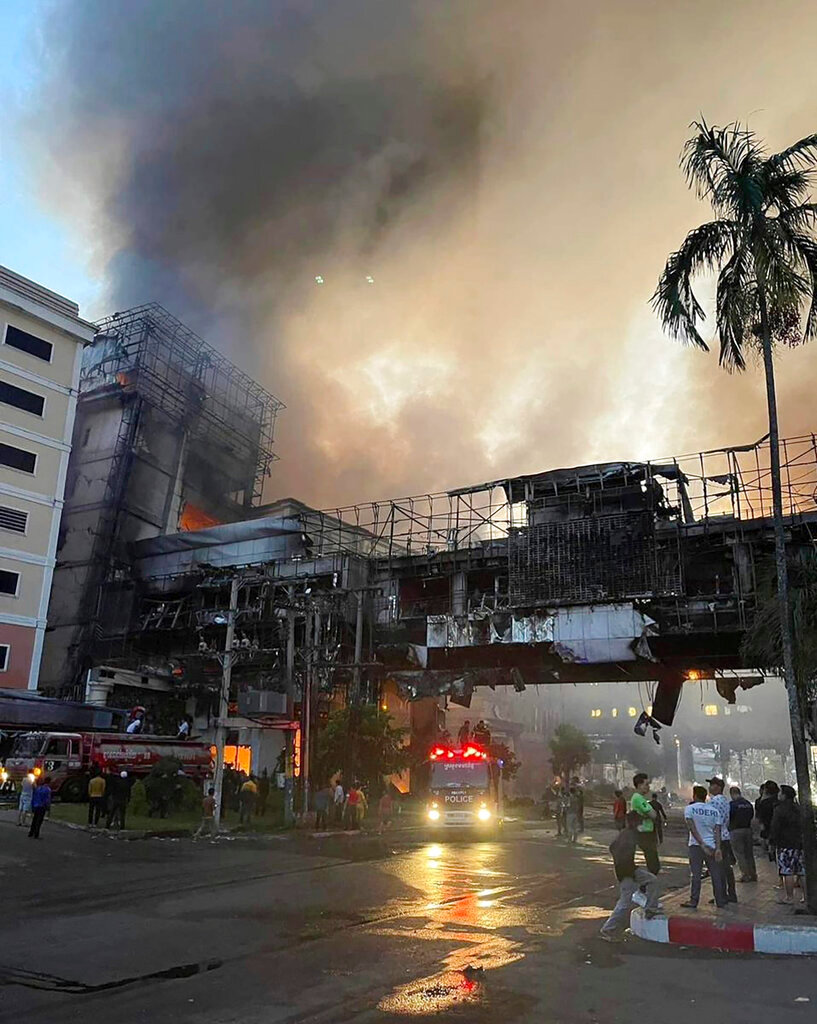 Smoke rises as a fire burns through a Cambodian hotel casino near a Cambodia-Thai international border gate in Poipet, west of Phnom Penh, Cambodia, Thursday, Dec. 29, 2022. (Fresh News/Photo via AP)