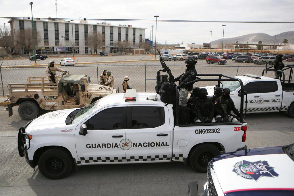 Mexican National Guard stand guard outside a state prison in Ciudad Juarez, Mexico, Sunday, Jan 1, 2023. (AP Photo/Christian Chavez)