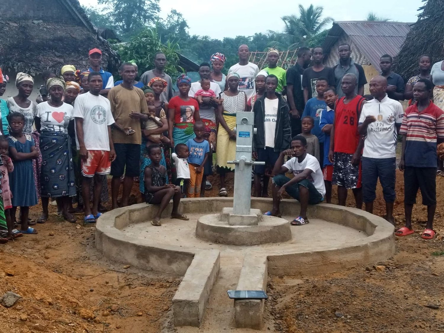 Residents of a Liberian village pose with their new water well completed by Liberia Mission Outreach International.