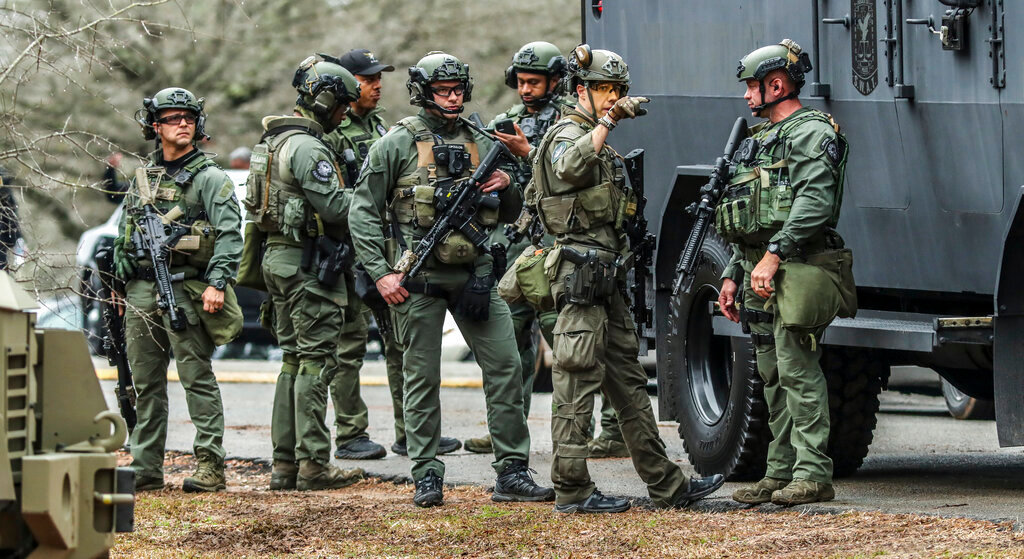 DeKalb and Atlanta SWAT members leave the Gresham Park command post in Atlanta on Wednesday, Jan. 18, 2023. (John Spink/Atlanta Journal-Constitution via AP)