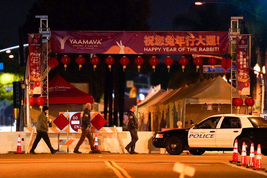 FBI agents walk near a scene where a shooting took place in Monterey Park, Calif., Sunday, Jan. 22, 2023. Nine people were killed in a mass shooting late Saturday in a city east of Los Angeles following a Lunar New Year celebration that attracted thousands, police said. (AP Photo/Jae C. Hong)