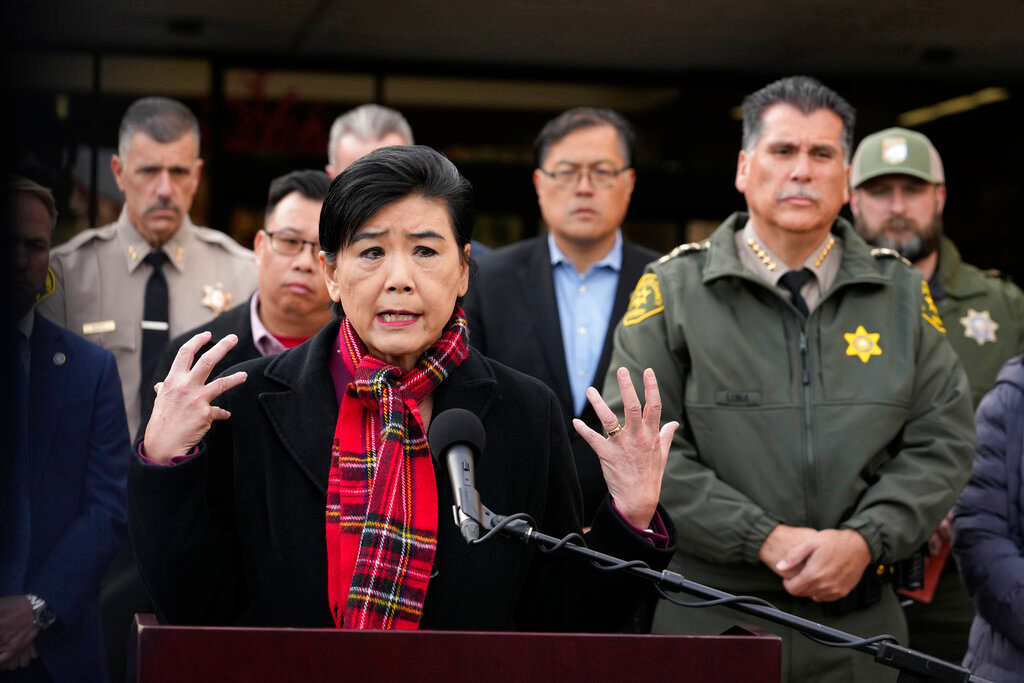 Rep. Judy Chu, D-Calif., left, addresses the media with Los Angeles County Sheriff Robert Luna, right, outside the Civic Center in Monterey Park, Calif., Sunday, Jan. 22, 2023. A mass shooting took place at a dance club following a Lunar New Year celebration, setting off a manhunt for the suspect. (AP Photo/Damian Dovarganes)
