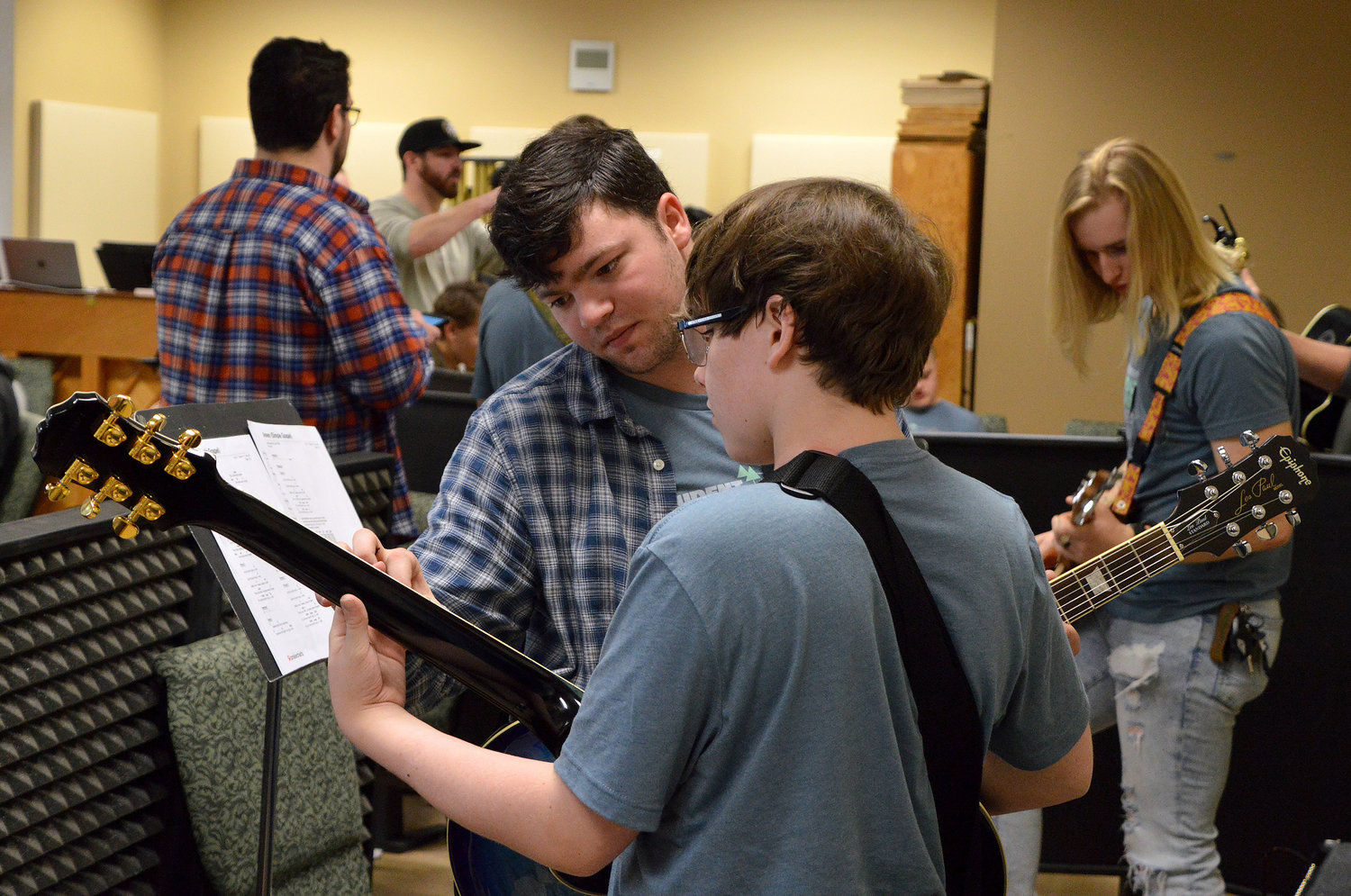 Caleb Hutchins, rear, helps Evan Purser with his guitar work during a praise team rehearsal at REEL Fest 2023 held at First Baptist Church of Jonesboro, Ga., Saturday, Jan. 21, 2023. (Index/Henry Durand)