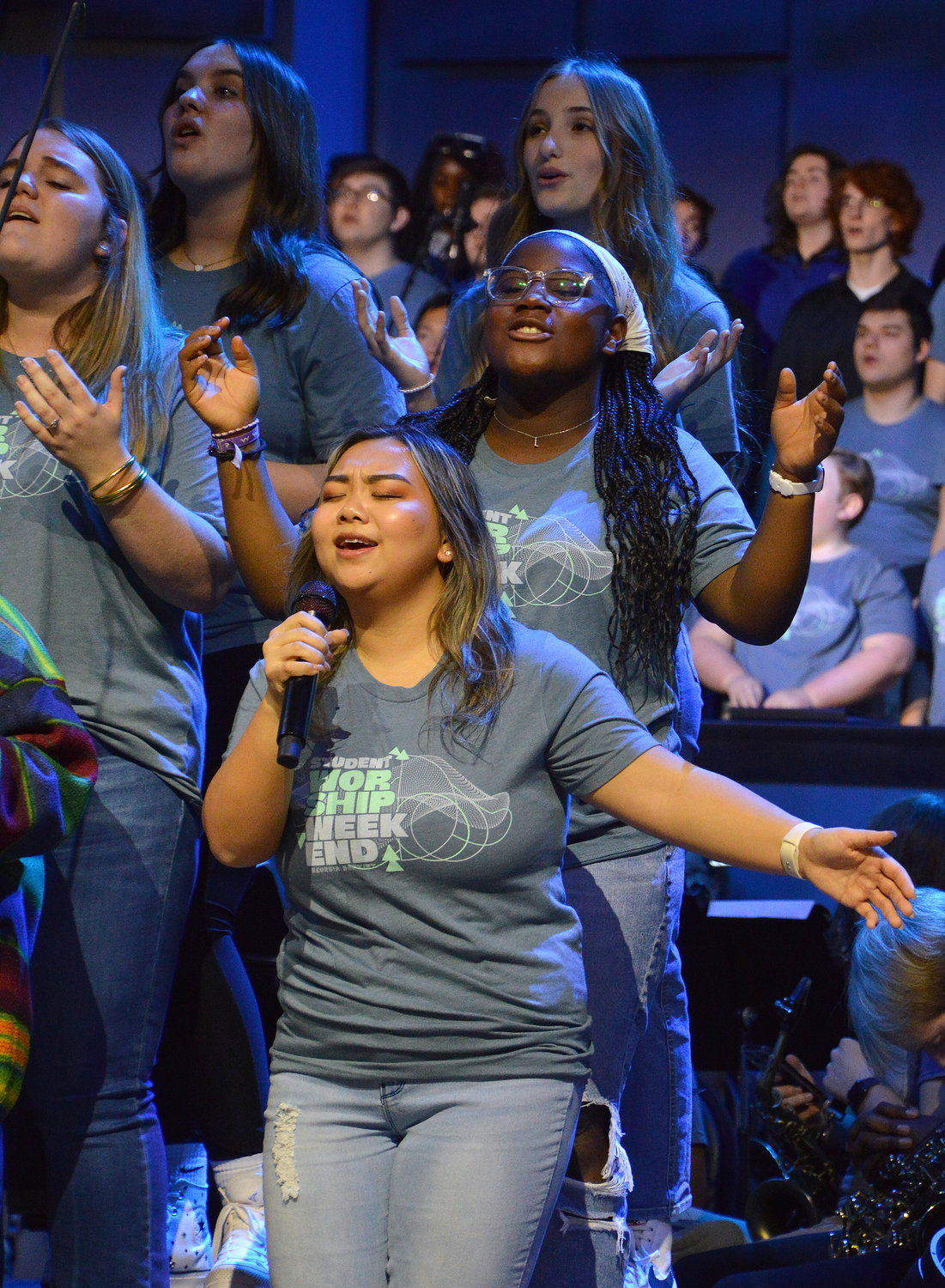 Kristy Xiong, Lily Allred and Ellie Keffer, from front, sing during a worship concert at the conclusion of REEL Fest 2023 held at First Baptist Church of Jonesboro, Ga., Saturday, Jan. 21, 2023. (Index/Henry Durand)