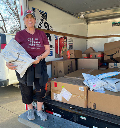 Teri Ussery from the Woman’s Missionary Union of Texas helps unload packages from an Amazon gift registry that WMU groups and individuals bought for Mary’s House. (Photo/Southwestern Baptist Theological Seminary)