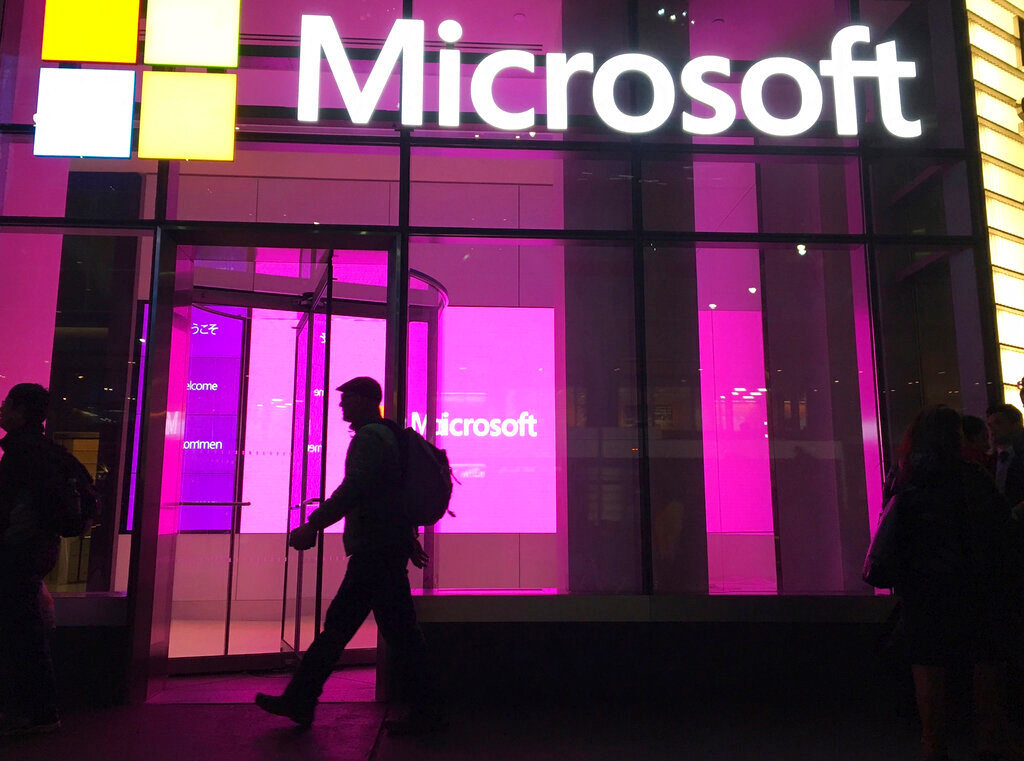 Microsoft said it's seeing some improvement to problems with its online services including the Teams messaging platform and Outlook email system after users around the world reported outages Wednesday. (AP Photo/Swayne B. Hall, File)