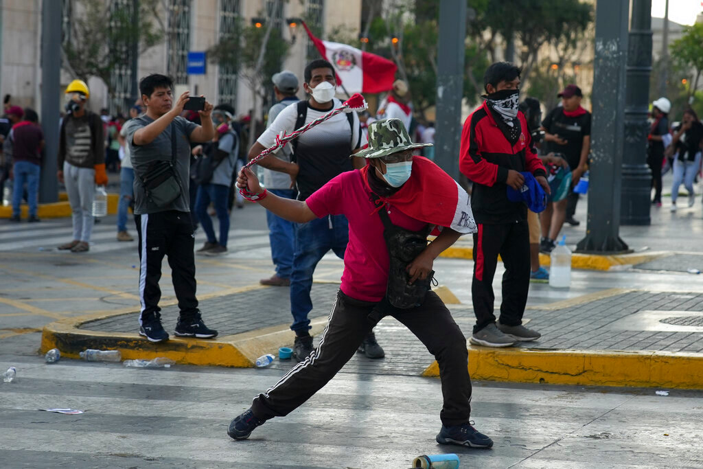 Anti-government protesters clash with police in Lima, Peru, Tuesday, Jan. 24, 2023. (AP Photo/Guadalupe Pardo)