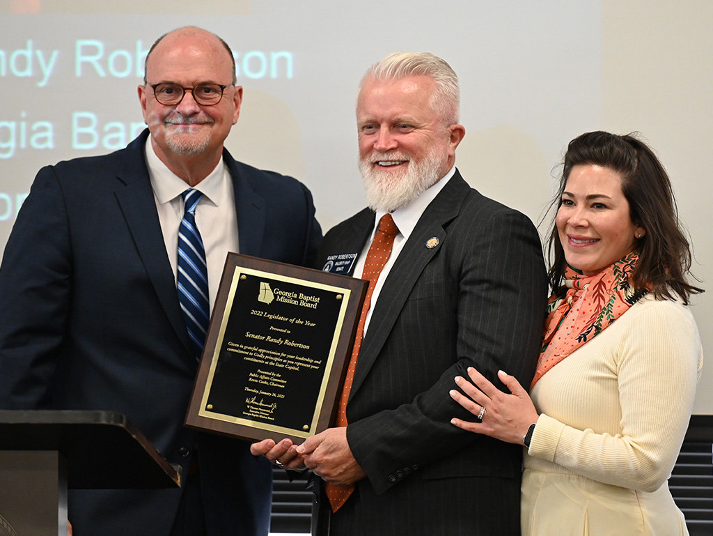 Georgia Baptist Mission Board Executive Director W. Thomas Hammond, left, presents state Sen. Randy Robertson with the 2022 Legislator of the Year Award during a presentation at the Capitol in Atlanta, Thursday, Jan. 26, 2023. Robertson's wife Theresa is at right. (Index/Henry Durand)
