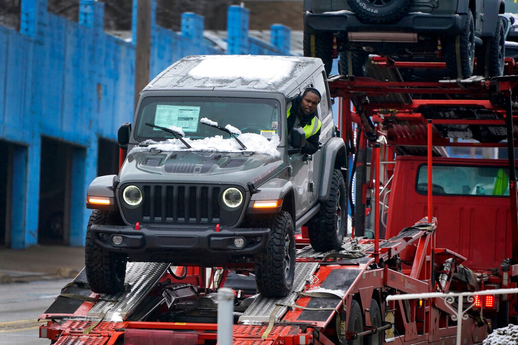A new Jeep is delivered to a dealership in Pittsburgh on Monday, Jan. 23, 2023. (AP Photo/Gene J. Puskar)