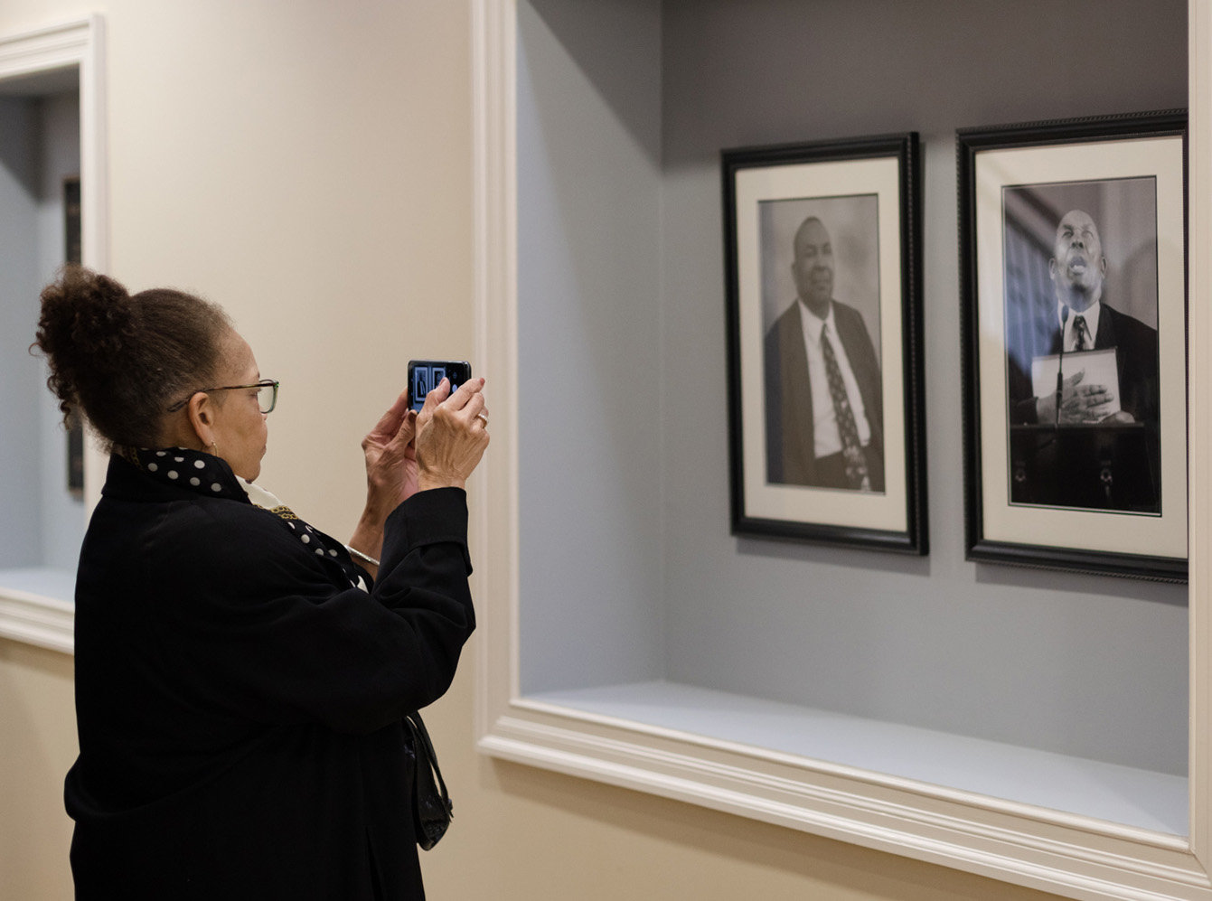 A guest takes a photo of an exhibit honoring the late Ralph Logan Carson. (Photo/Southeastern Baptist Theological Seminary)