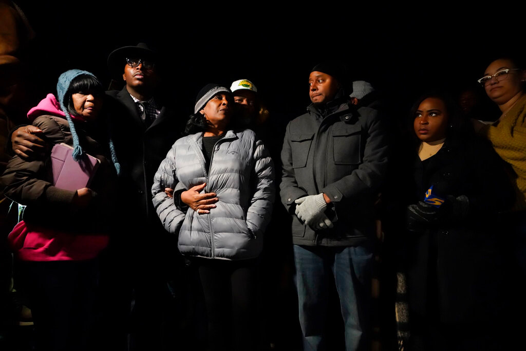 RowVaughn Wells, center, mother of Tyre Nichols, who died after being beaten by Memphis police officers, is comforted by his stepfather Rodney Wells, at the conclusion of a candlelight vigil for Tyre, in Memphis, Tenn., Thursday, Jan. 26, 2023. (AP Photo/Gerald Herbert)
