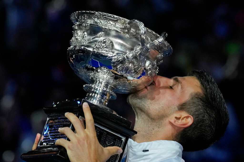 Novak Djokovic of Serbia kisses the Norman Brookes Challenge Cup after defeating Stefanos Tsitsipas of Greece in the men's singles final at the Australian Open in Melbourne, Australia, Sunday, Jan. 29, 2023. (AP Photo/Aaron Favila)