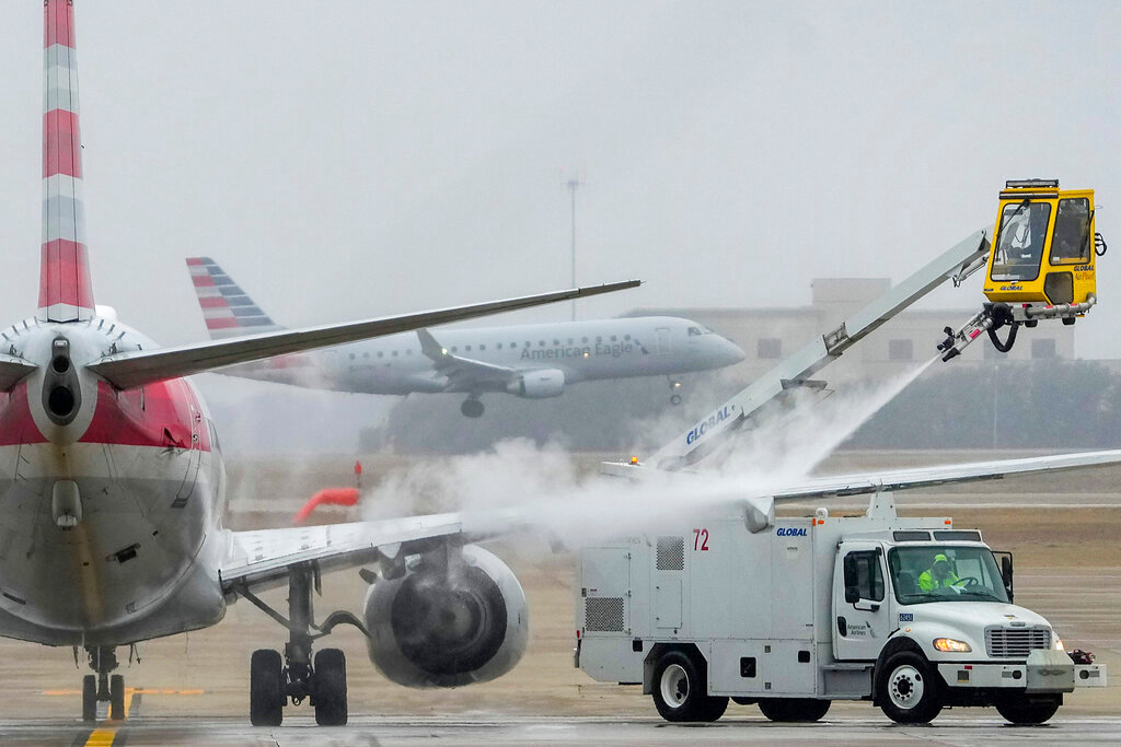 An American Airlines aircraft undergoes deicing procedures on Monday, Jan. 30, 2023, at Dallas/Fort Worth International Airport in Texas. (Lola Gomez/The Dallas Morning News via AP)